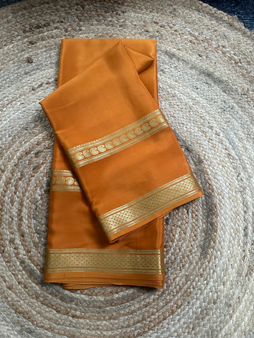 Golden mustard self bentex border pure crepe Mysore Silk sarees.