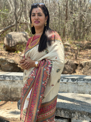 Half white pure moonga crepe with Kashmiri weaving. Pink Brocade blouse.