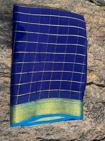 Navy blue with sky blue Mysore Silk crepe checks all over the body with contrast border. 75 grams thickness.