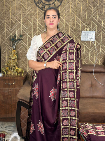 Wine pure modal silk with Ajrak Gajji pallu. And checks border.
