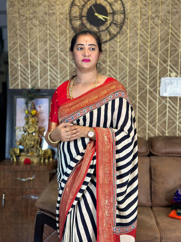 Modal dola silk with black stripes zari border pallu.