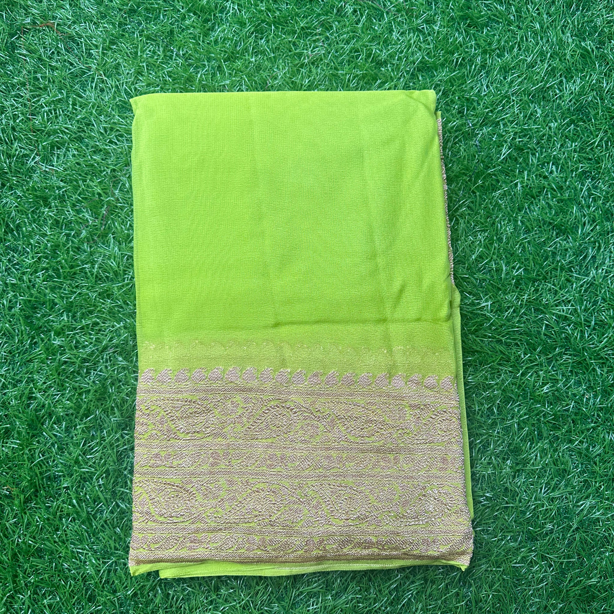 Neon green pure georgette Banaras. Rice pallu and self blouse.