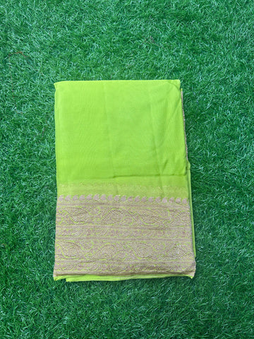 Neon green pure georgette Banaras. Rice pallu and self blouse.