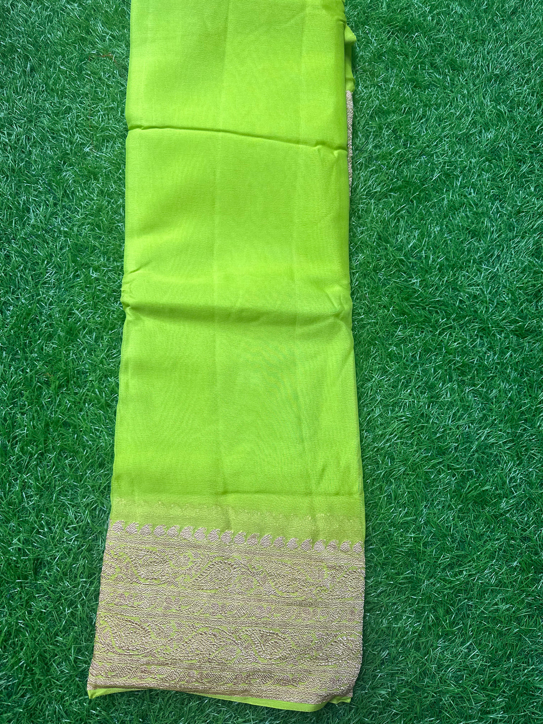 Neon green pure georgette Banaras. Rice pallu and self blouse.