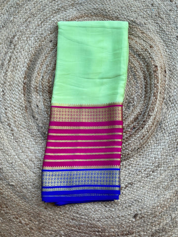 Pistha green with pink and purple Rudrakshi border crepe Mysore silk 120 gsm