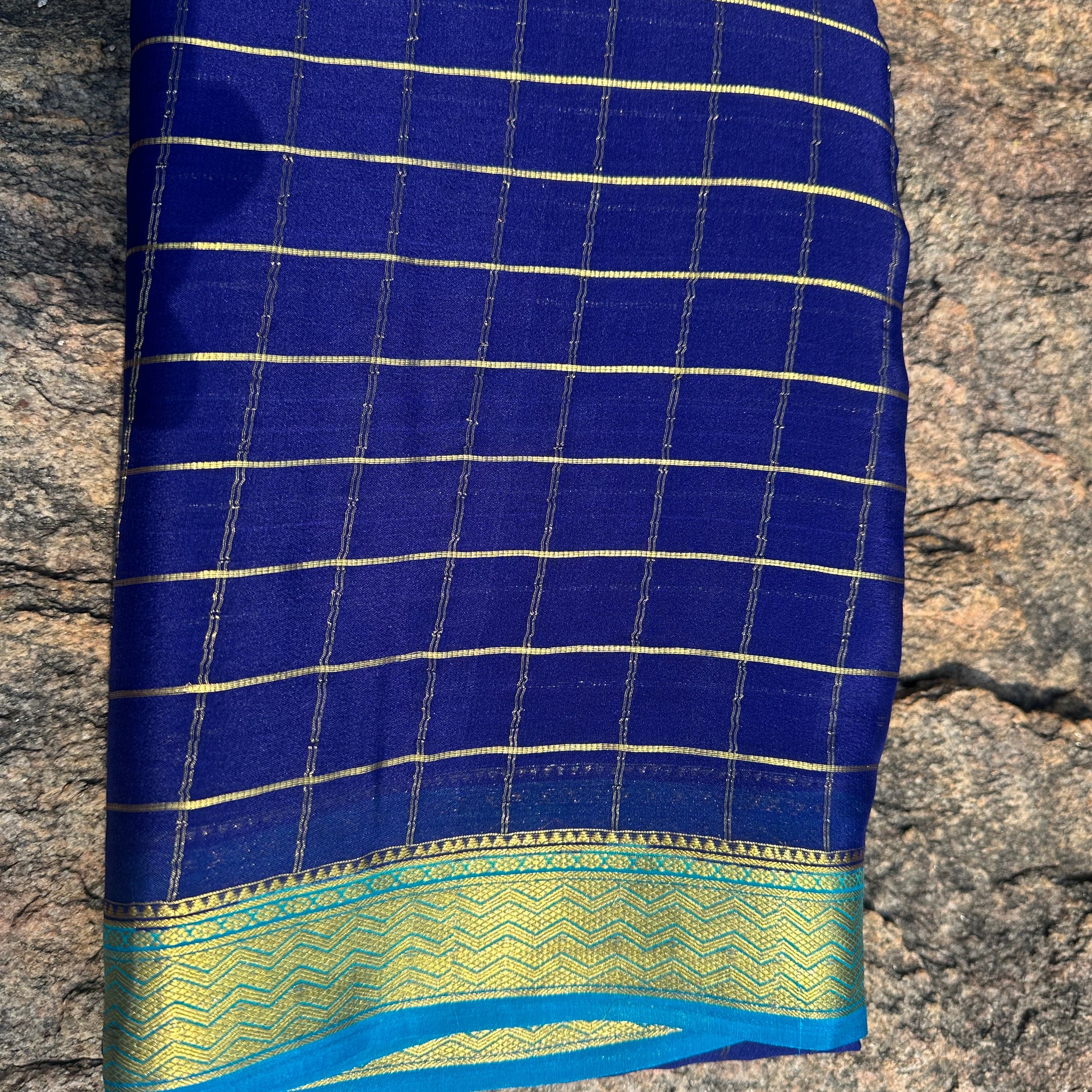 Navy blue with sky blue Mysore Silk crepe checks all over the body with contrast border. 75 grams thickness.