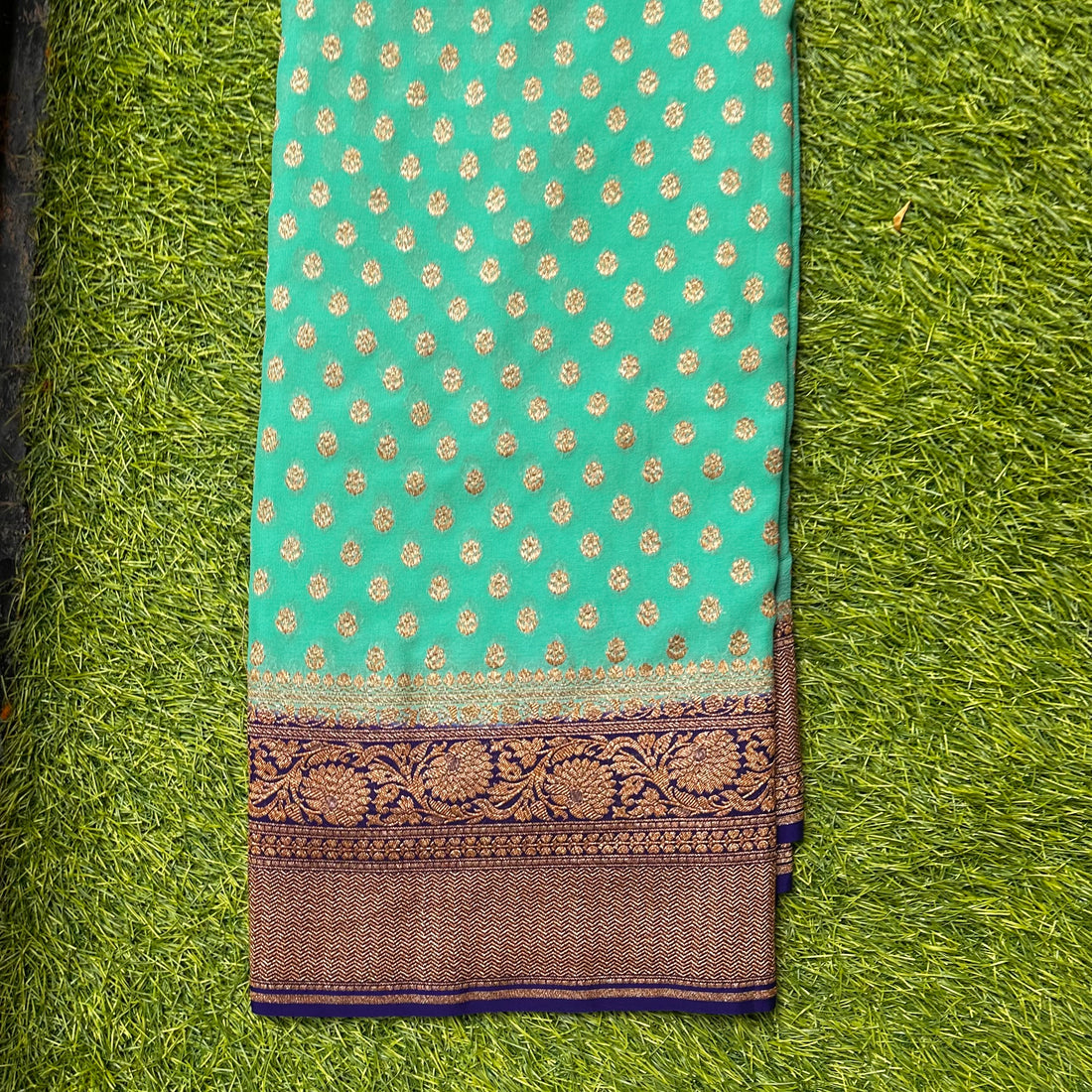 Pure khaddi georgette. Distemper green with navy blue.