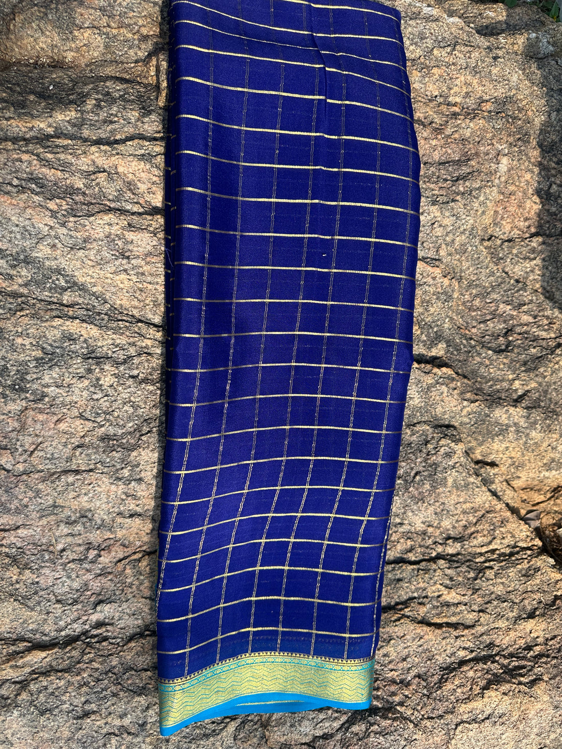 Navy blue with sky blue Mysore Silk crepe checks all over the body with contrast border. 75 grams thickness.