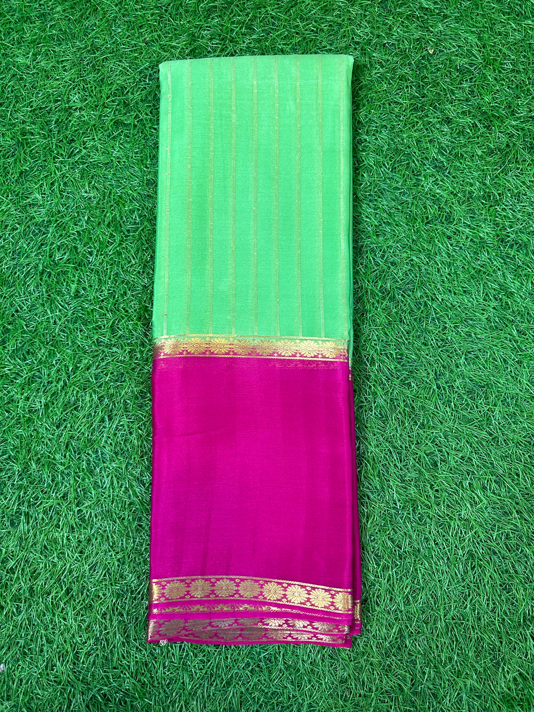 Light green with pink pure wrinkle crepe saree with vertical stripes blouse.